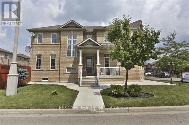 A brick house with a tree in front of it.