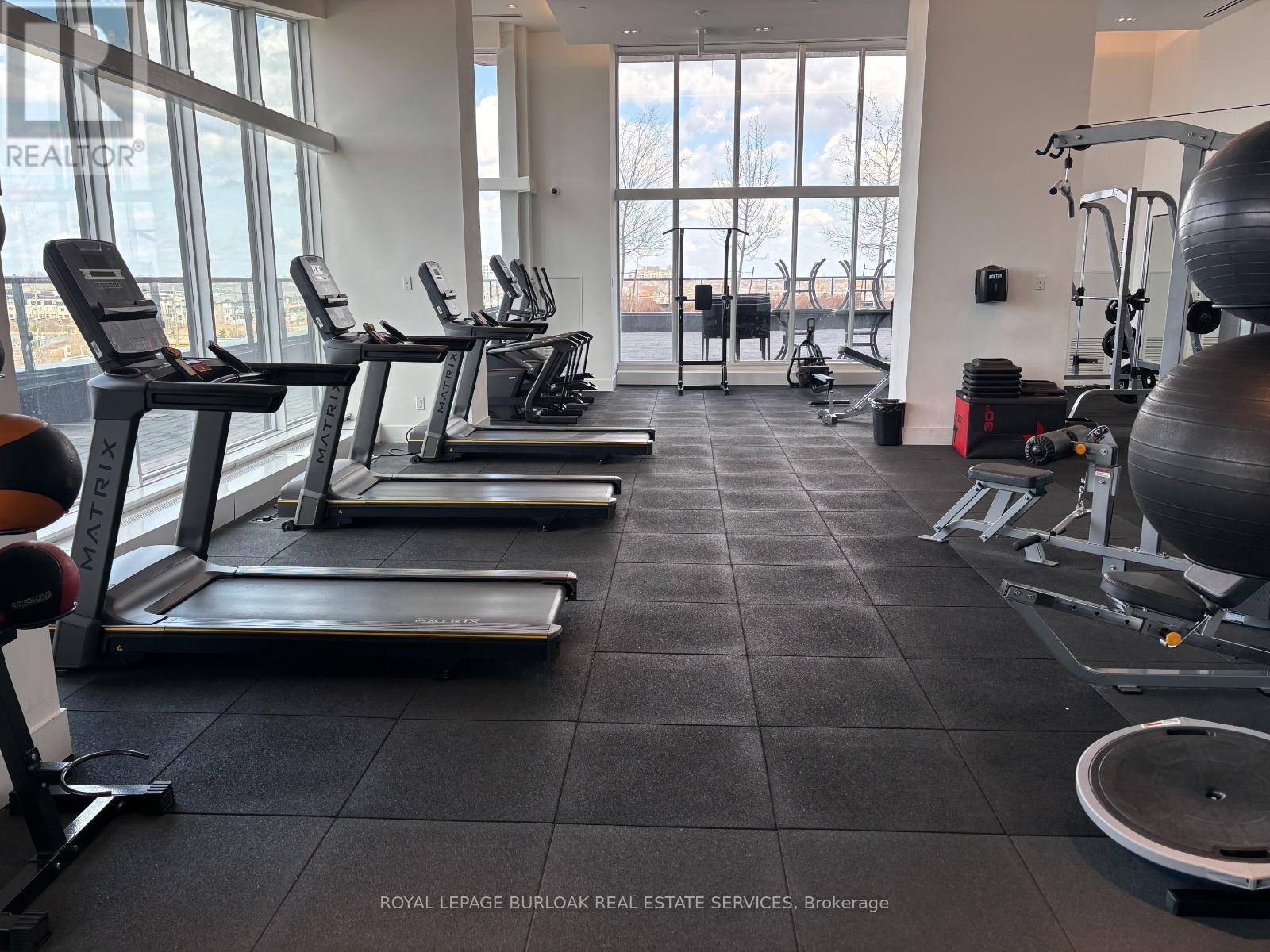 A gym with treadmills, exercise balls and other equipment.