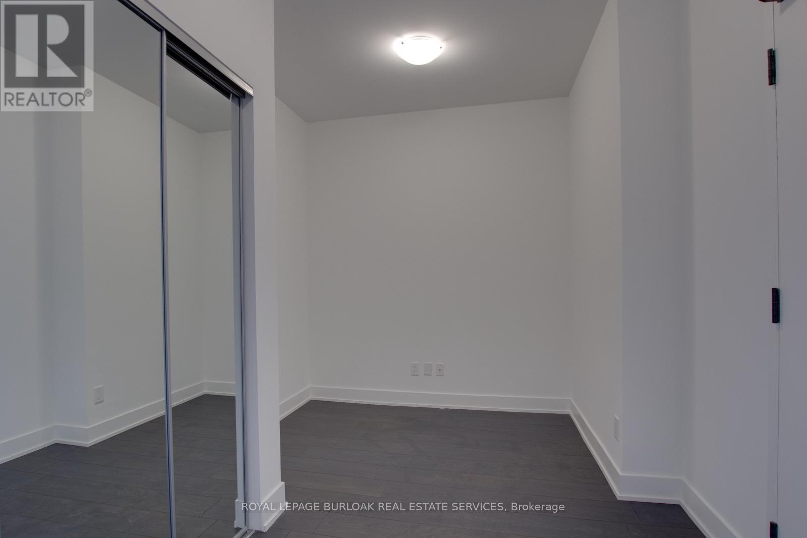 A room with a sliding glass door and carpeted floor.