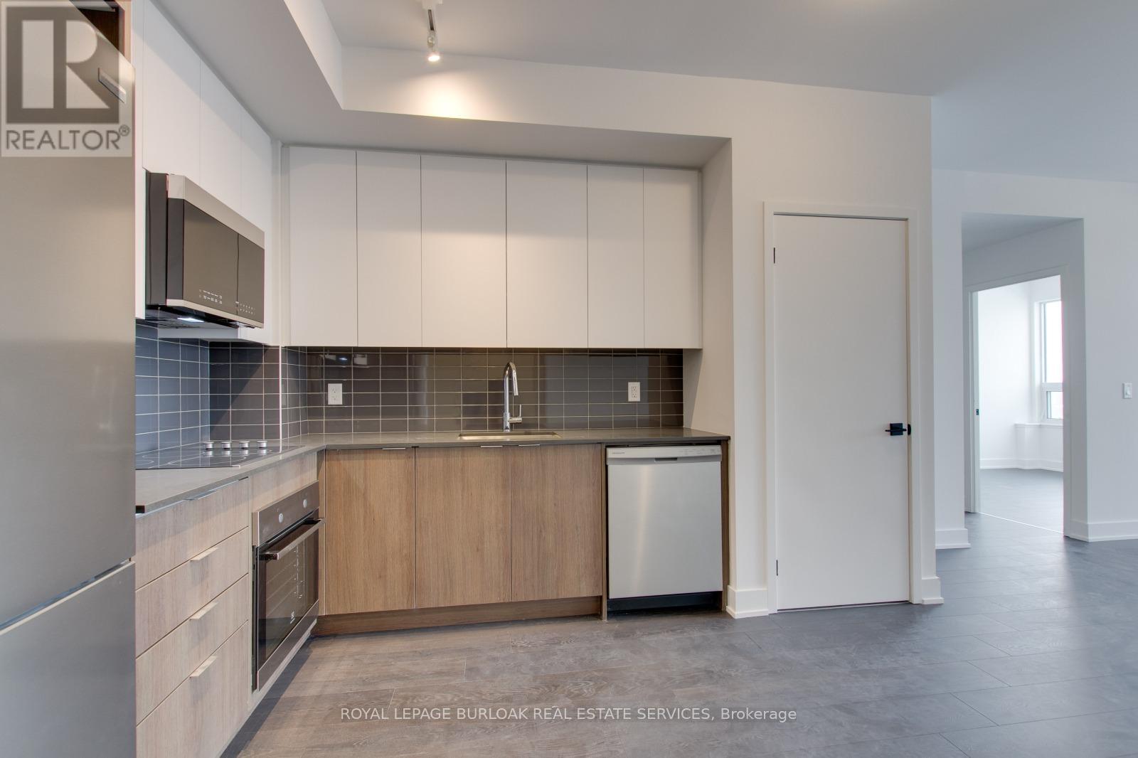 A modern kitchen with white cabinets and a wooden island.