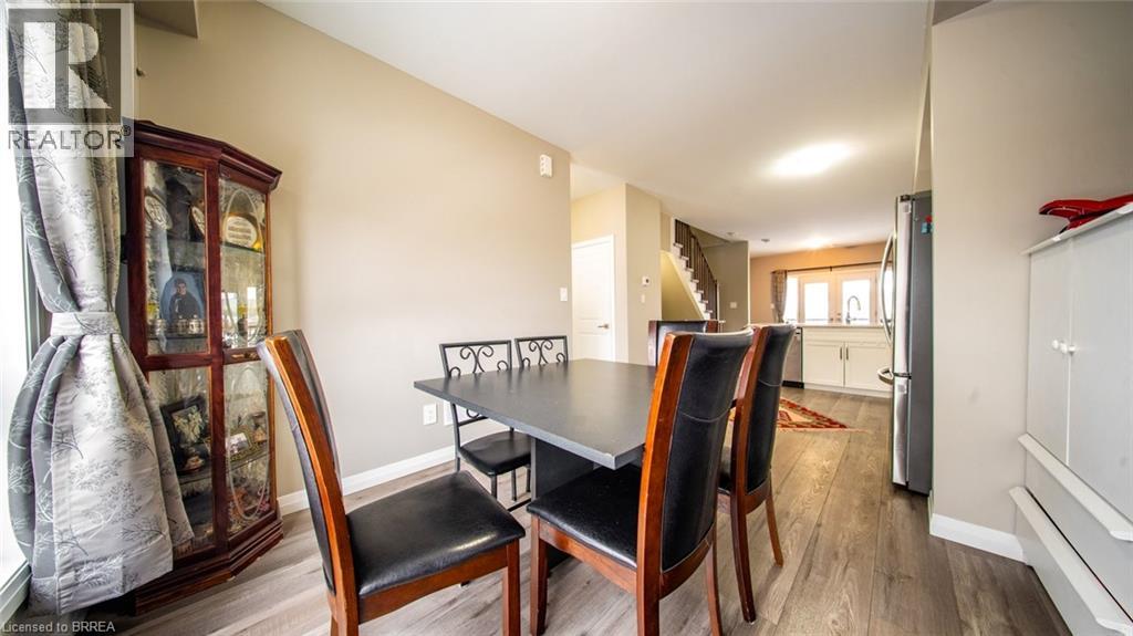 A dining room with a table and chairs.
