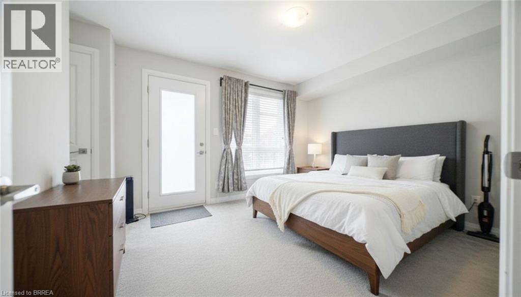 A bedroom with a large bed, a wooden dresser, and a window with curtains.