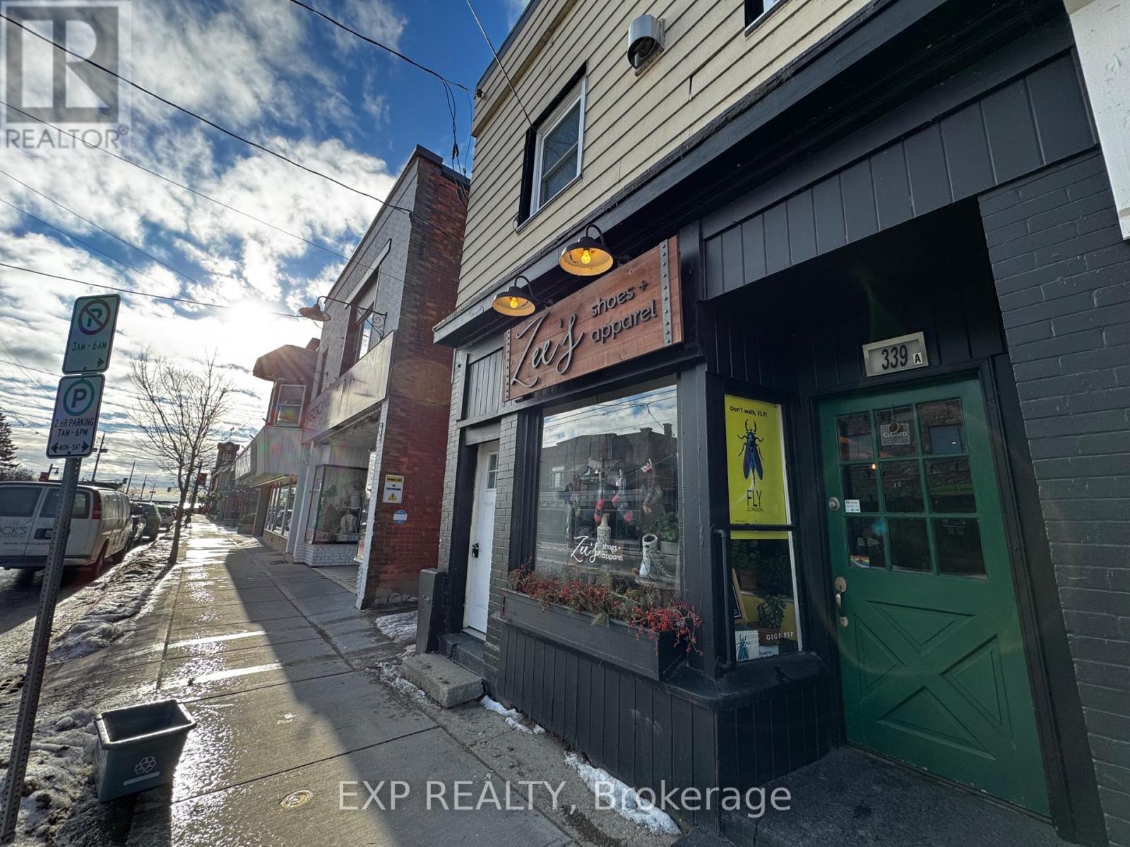 A street view of a building with a sign that says "EXP REALTY Brokerage".