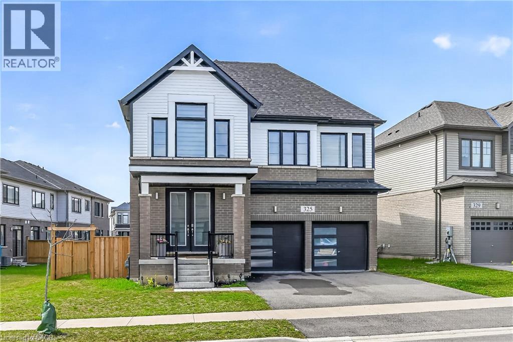 A modern two-story house with a garage is for sale.