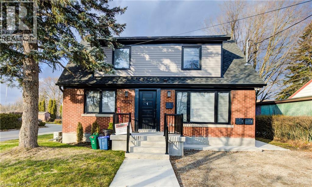 A house with a black front door and a sign that says "REALTOR".