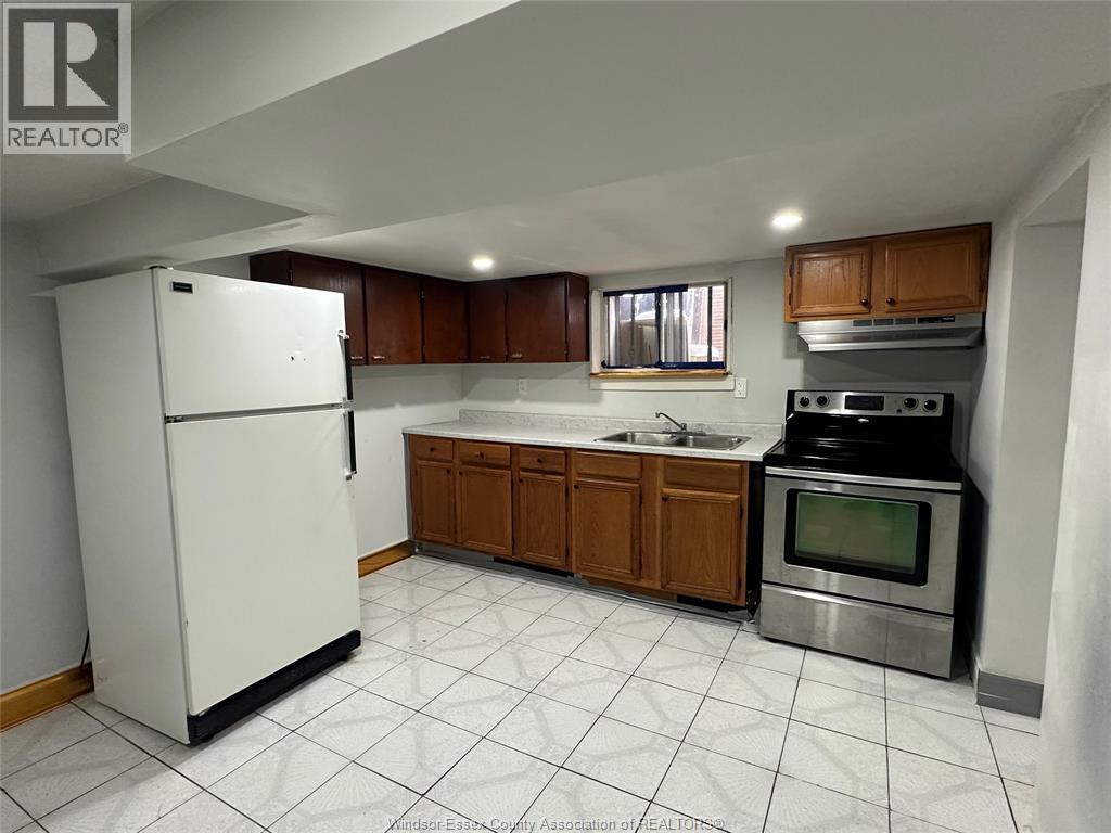 A kitchen with white appliances and wooden cabinets.