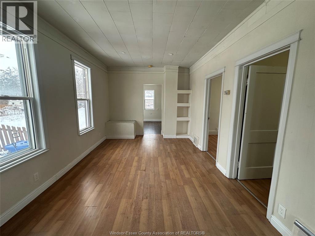 A room with wooden floors and white walls.