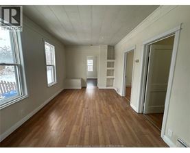 A room with wooden floors and white walls.