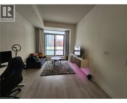 A living room with a black chair and a small table.