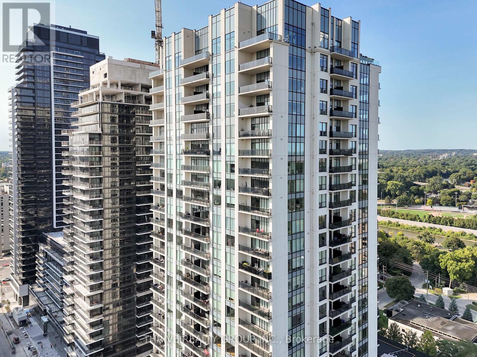 A tall building with many windows is under construction.