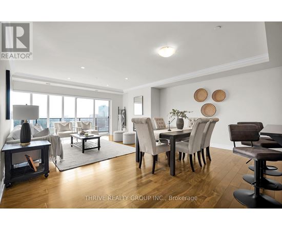 A modern living room with a dining area and a view of the city.