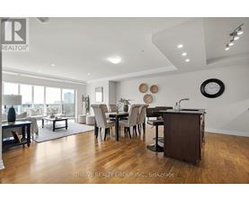 A well-lit, modern dining room with a large table and chairs.