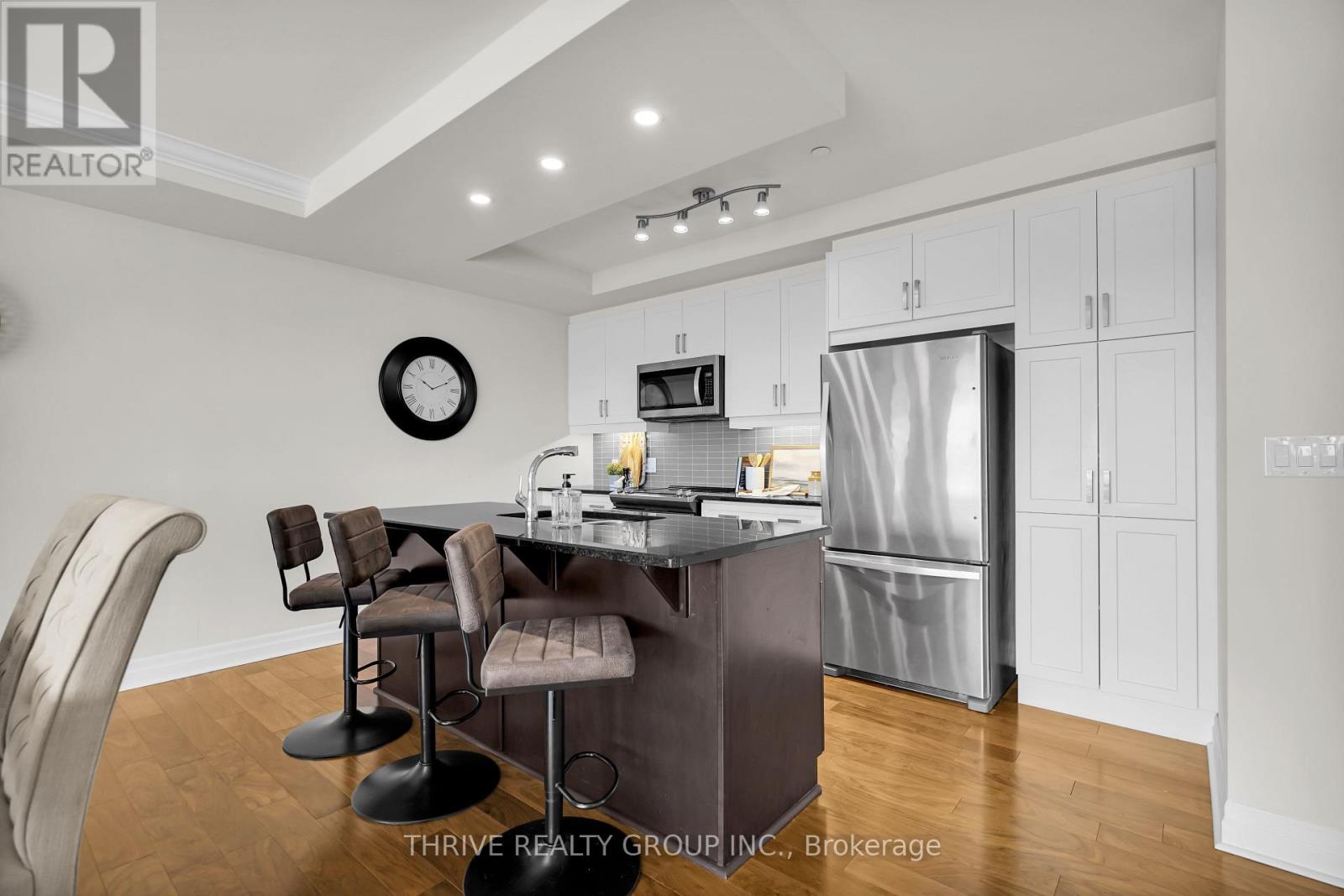 A modern kitchen with a dining table and chairs.