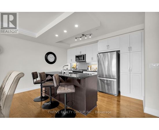 A modern kitchen with a dining table and chairs.