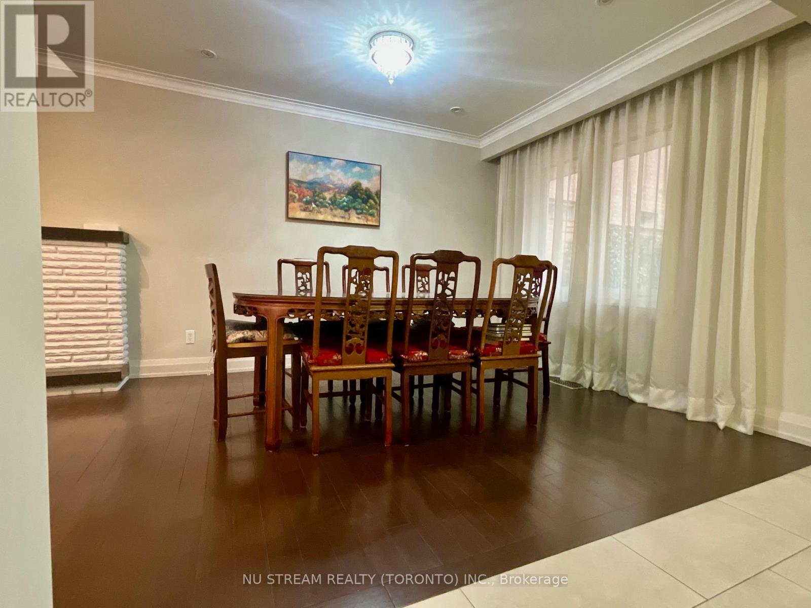 A dining room with a wooden table and chairs.
