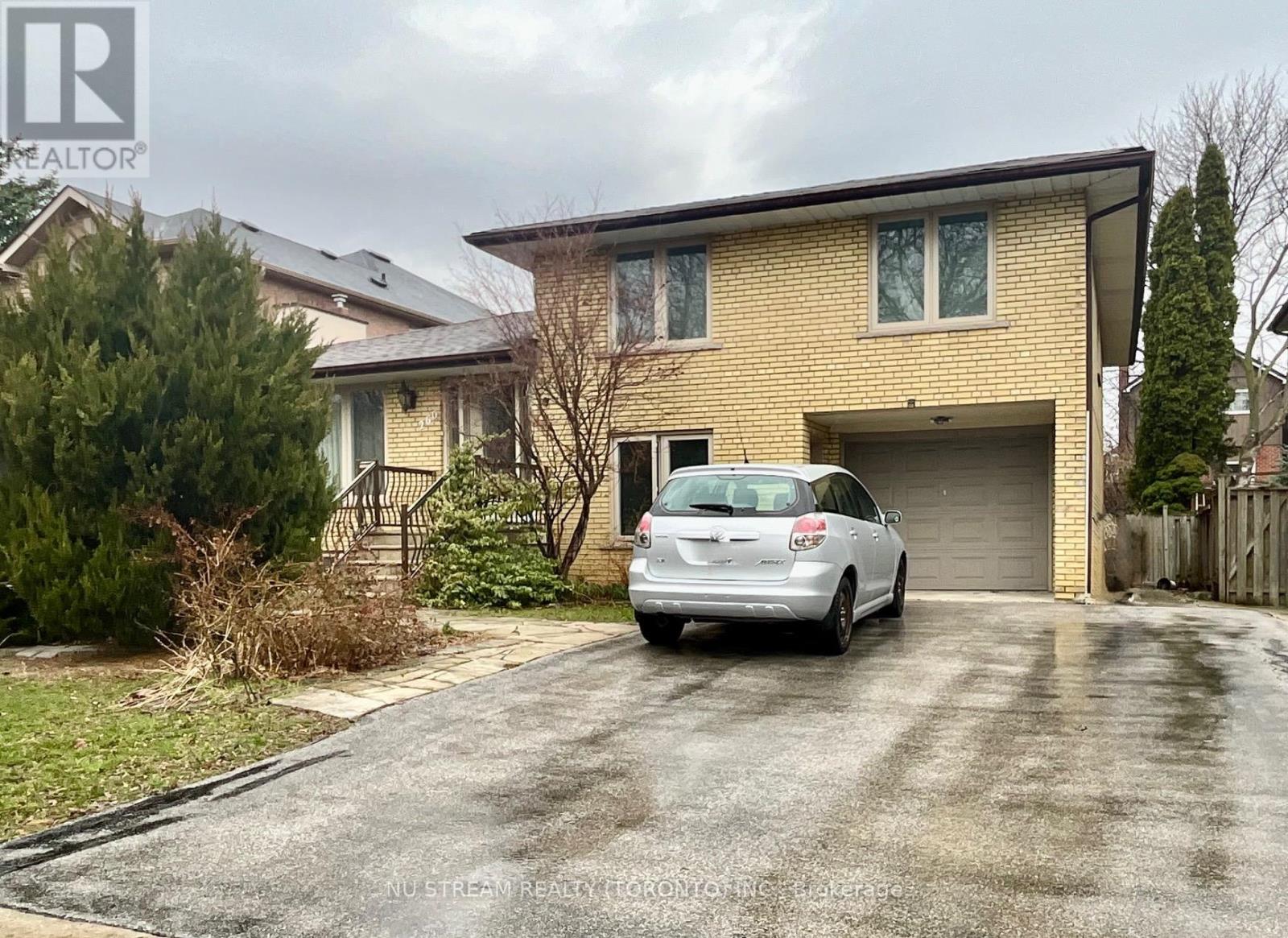 A house with a car parked in front of it.