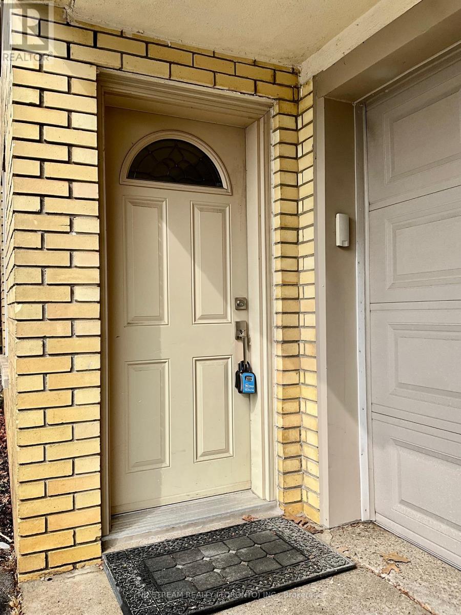 A white door with a black mat in front of it.