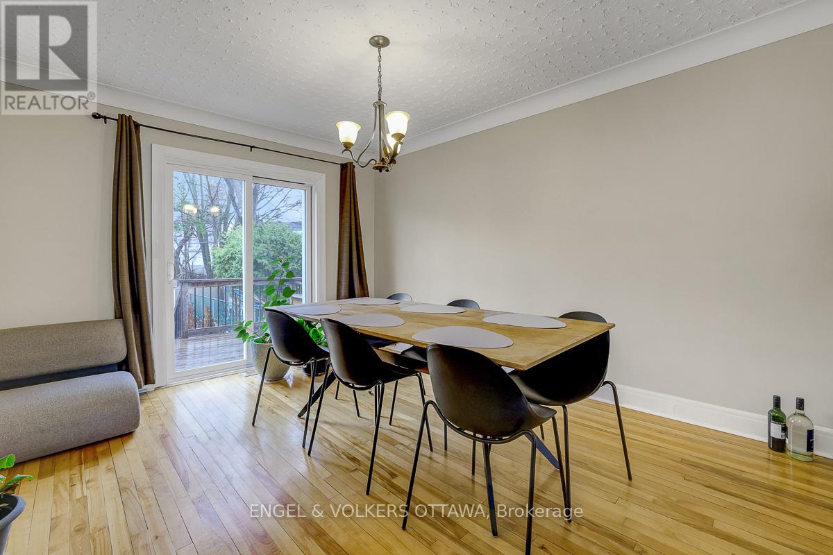 A dining room with a wooden table and chairs.
