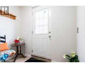 A small room with a white door and a table with flowers on it.