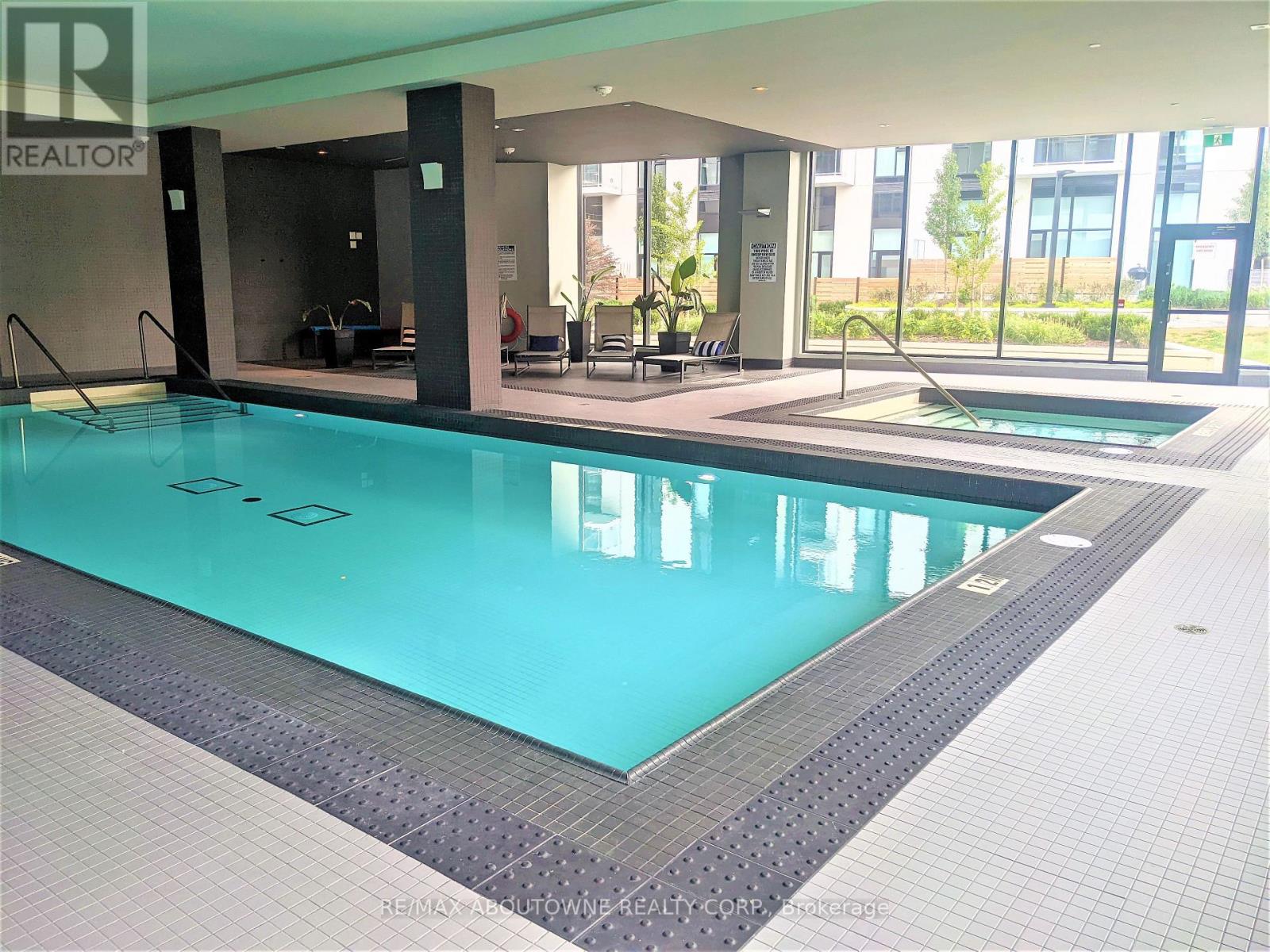 A large indoor swimming pool with a tiled edge.