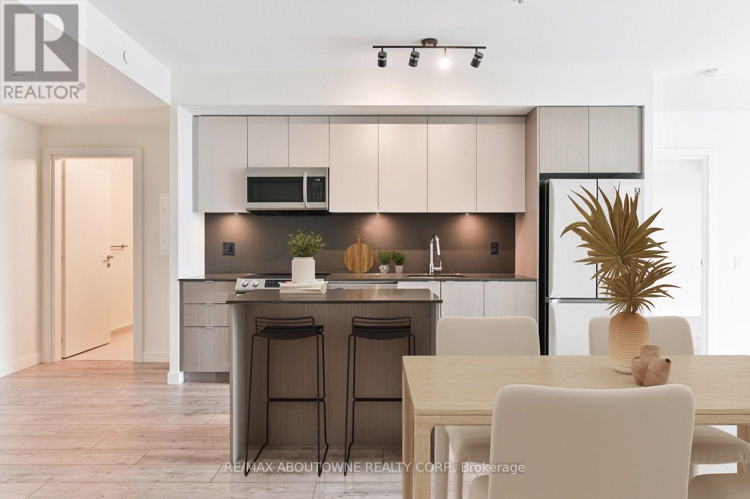 A modern kitchen with a dining table and chairs.