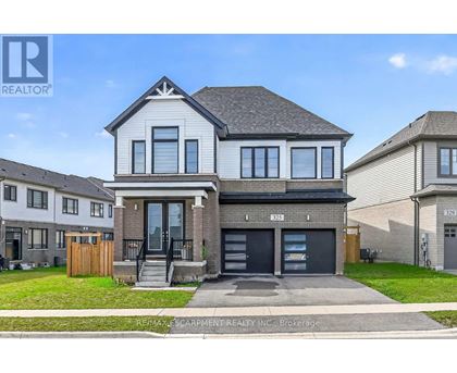 A modern two-story house with a garage is for sale.