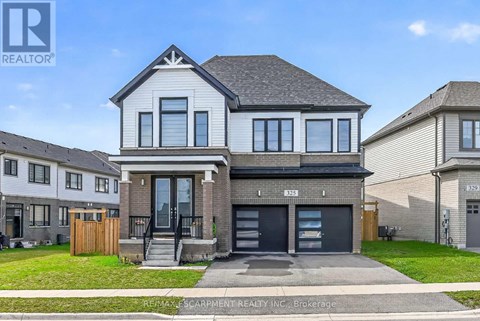 A modern two-story house with a garage is for sale.