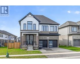 A modern two-story house with a garage is for sale.