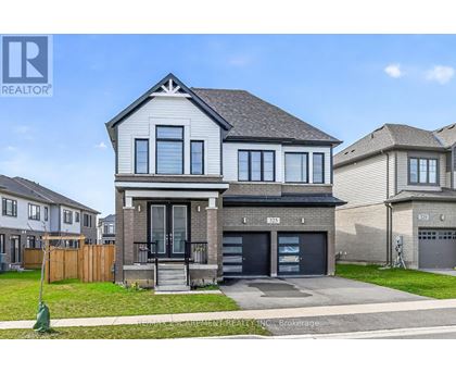 A modern two-story house with a garage is for sale.