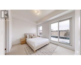 A bedroom with a large bed and a view of a balcony.