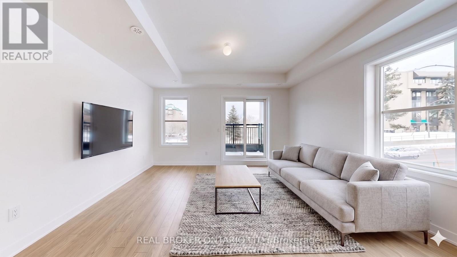 A living room with a couch, a coffee table, and a television.