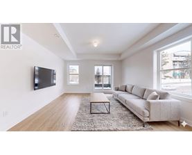 A living room with a couch, a coffee table, and a television.