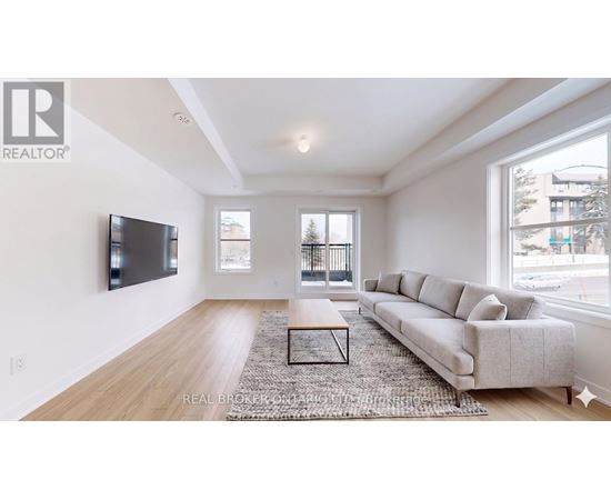 A living room with a couch, a coffee table, and a television.