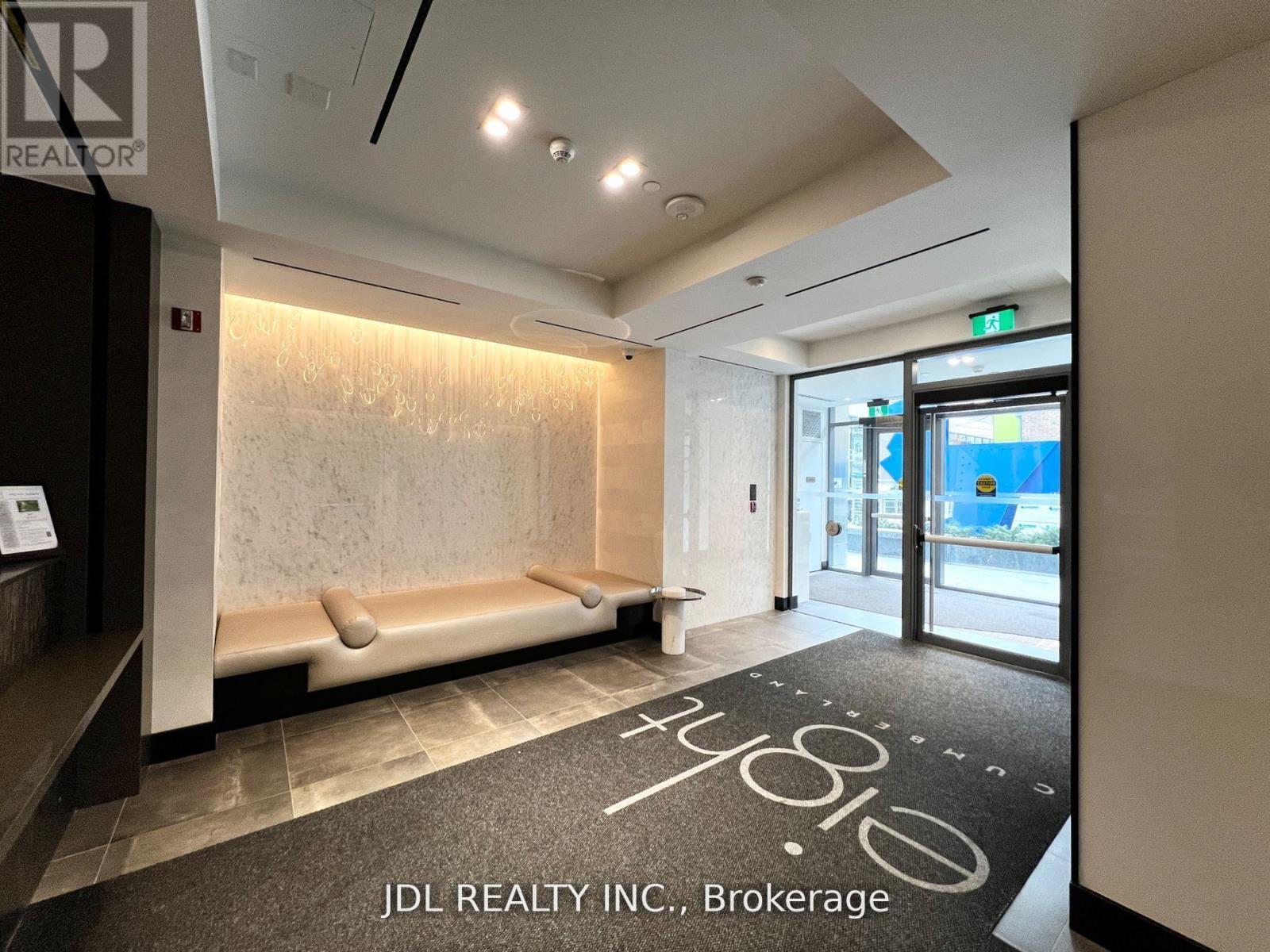 A hallway with a carpet that has the letters "JDL" on it.