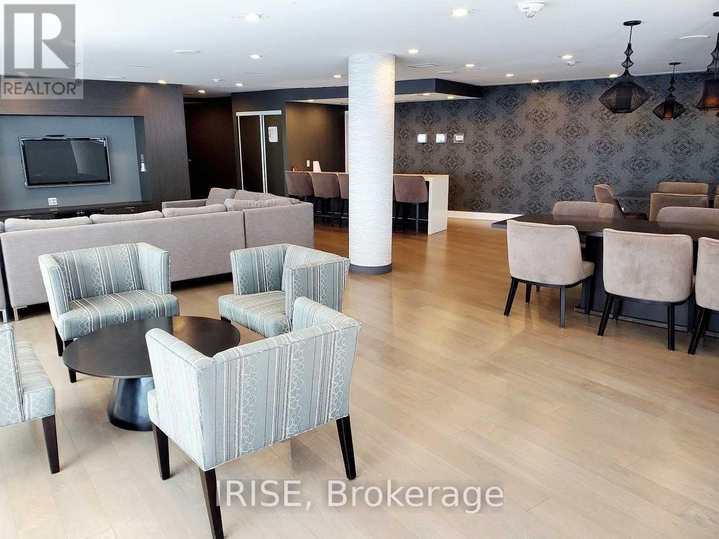 A living room with a grey sofa and chairs.