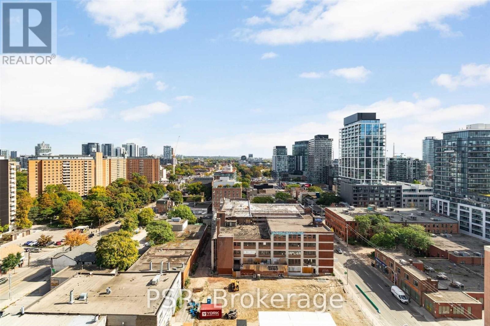 A cityscape with buildings and a clear sky.