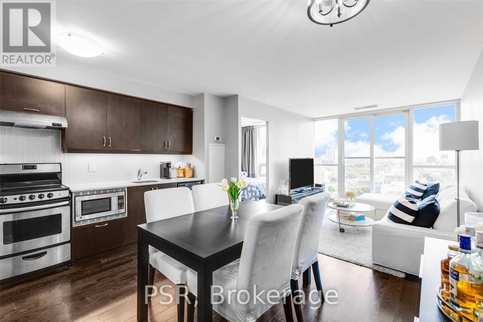 A modern kitchen with a dining table set for two.