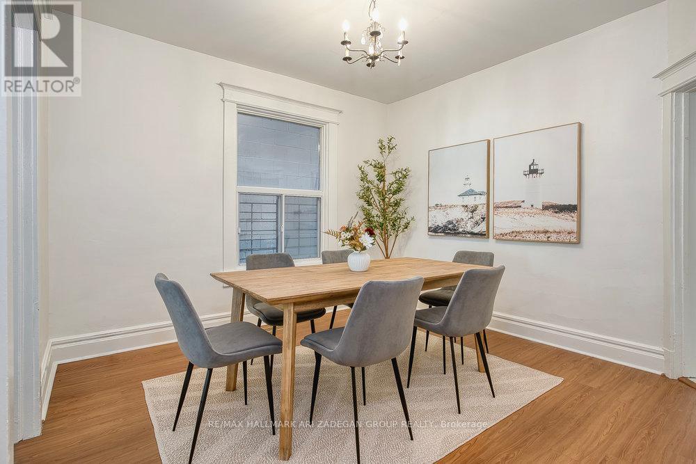 A dining room with a wooden table and grey chairs.