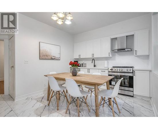 A kitchen with a table and chairs in the middle of the room.