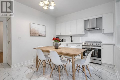 A kitchen with a table and chairs in the middle of the room.