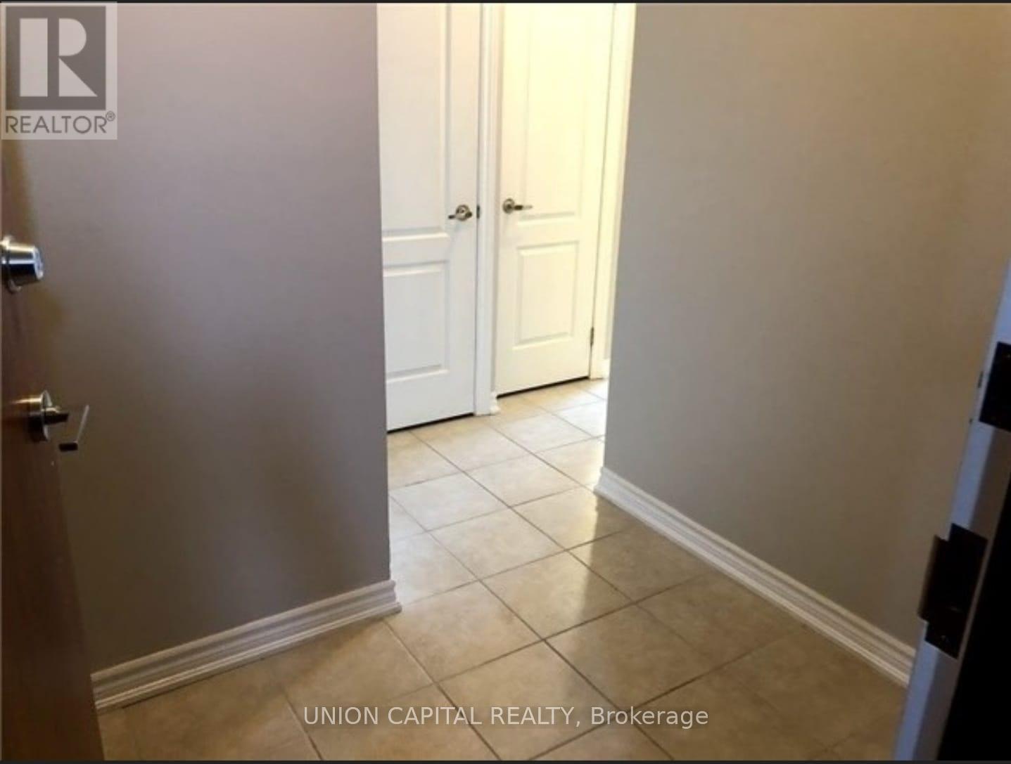 A hallway with a door on the left and a door on the right.