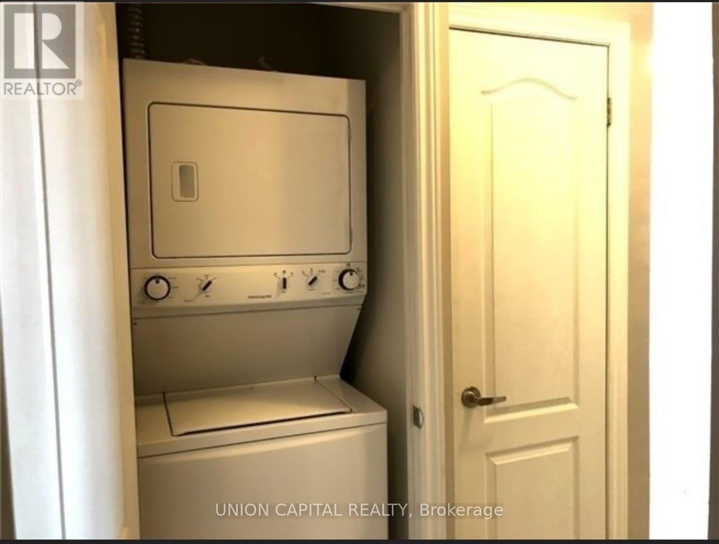A small white washer and dryer in a small room.