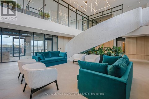 A living room with a white couch and a green couch.