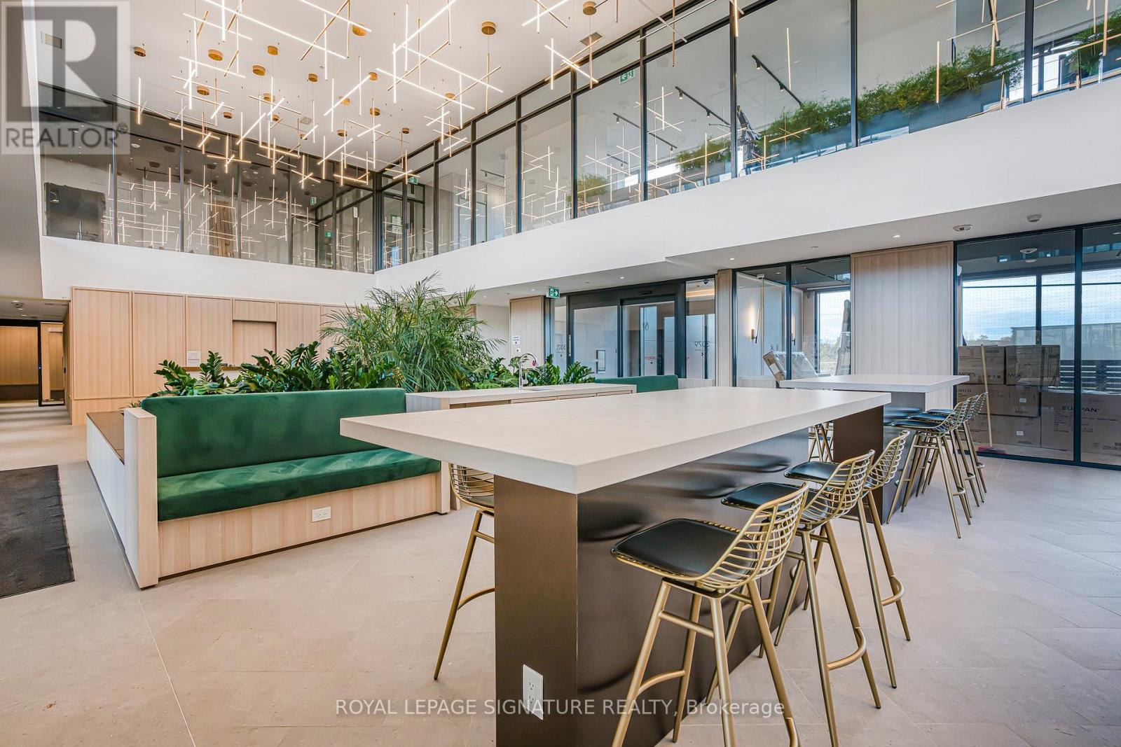 A modern dining area with a long table and chairs.
