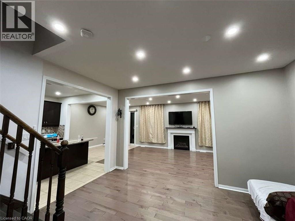 A living room with a fireplace and a television.