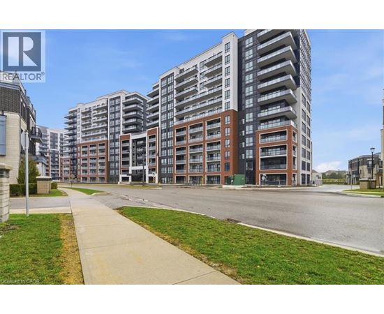 A large apartment complex with a walkway in front.