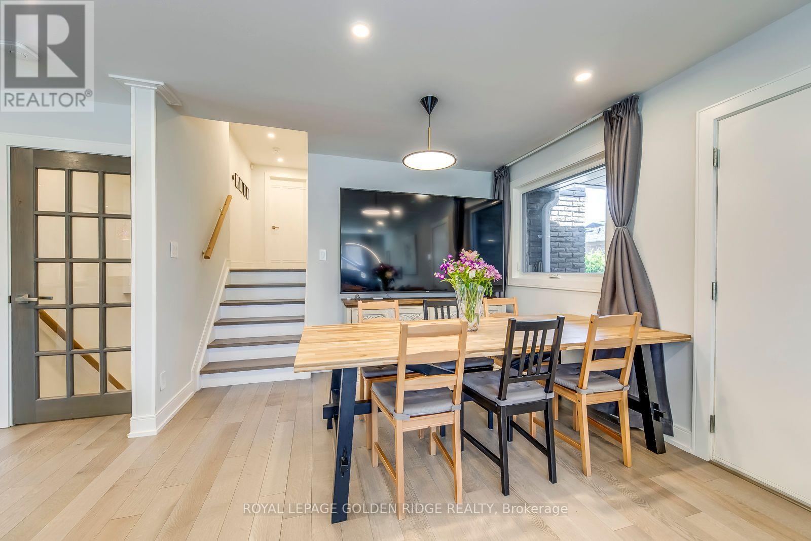 A dining room with a table set for four.