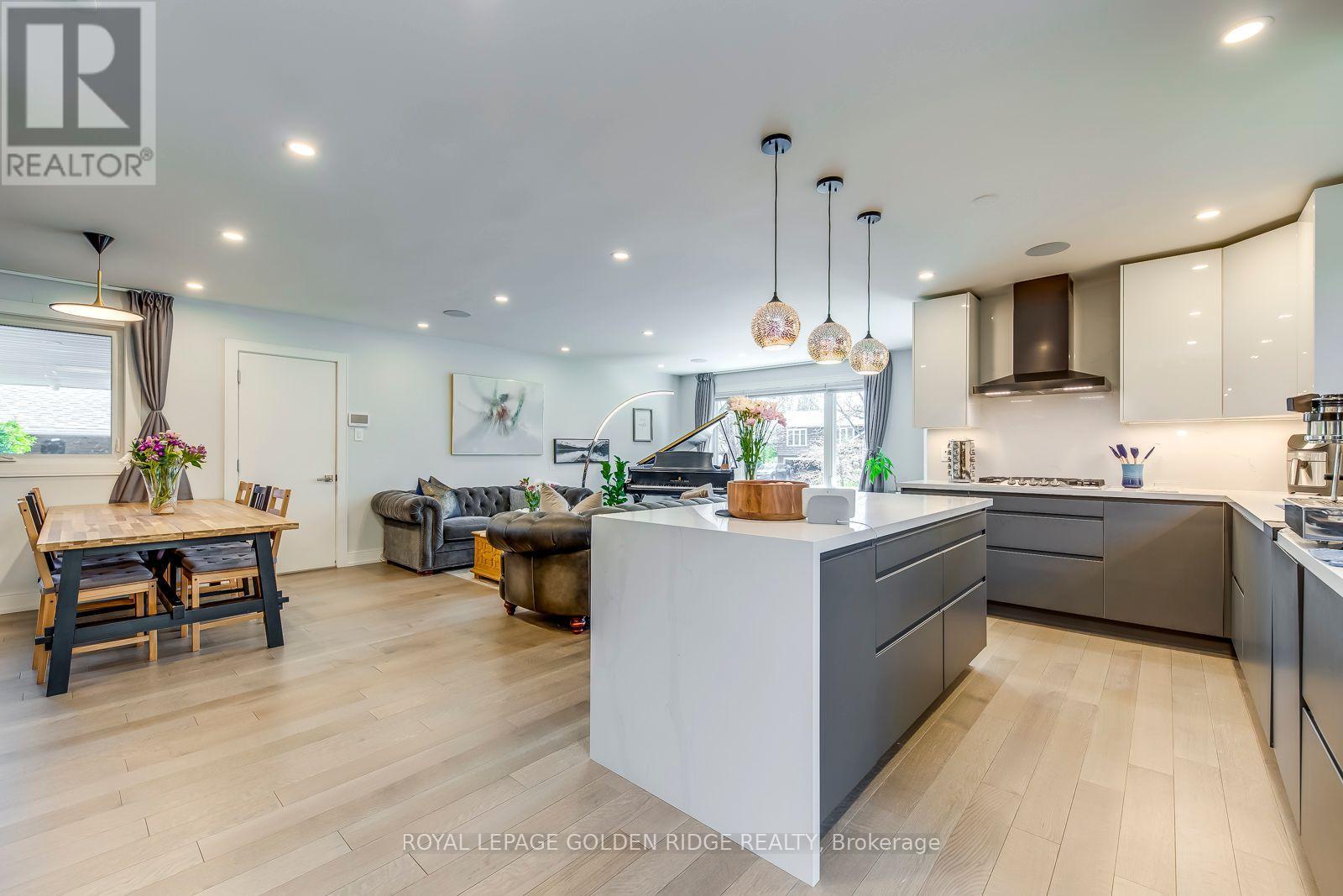 A modern kitchen with a dining table and chairs.