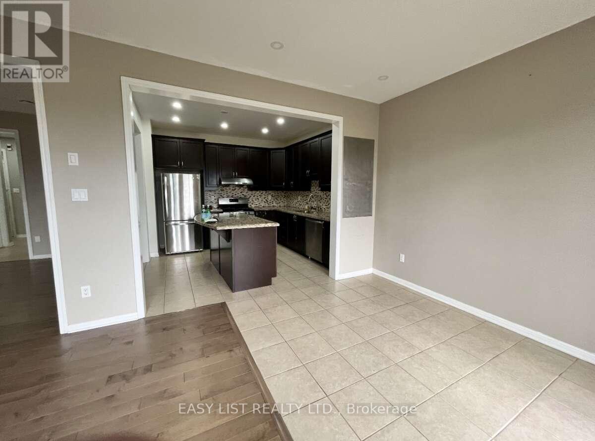 A spacious kitchen with dark wood cabinets and a central island.