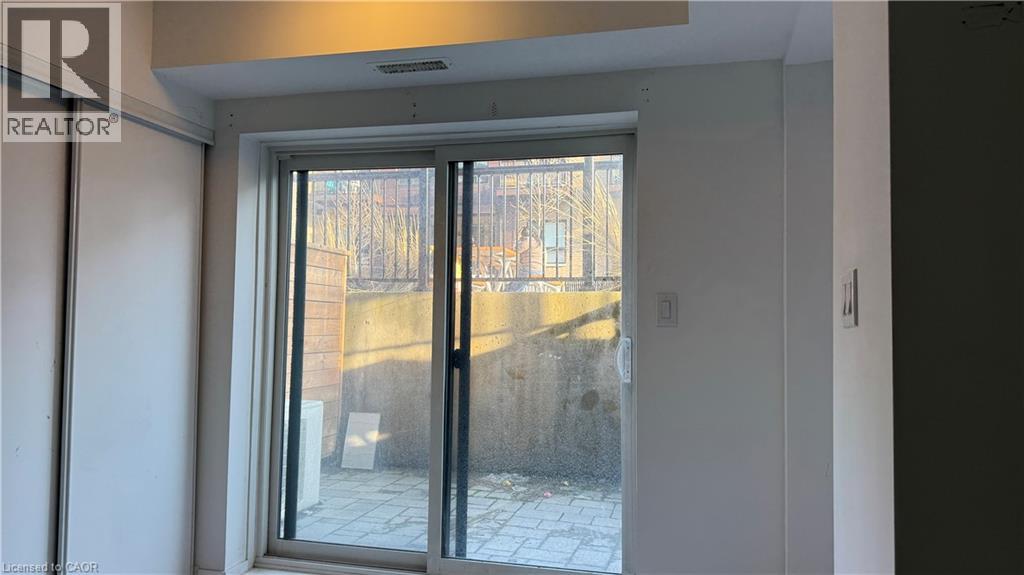 A realtor photo of a room with a glass door leading to a balcony.